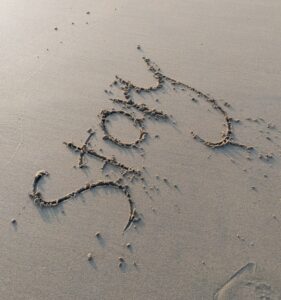 image of the word "story" written in the sand