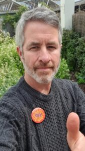 photo of Tim Drylie wearing Yes badge