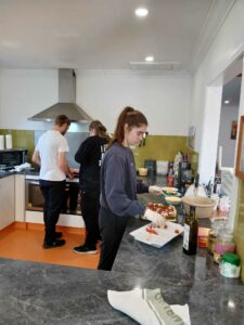 image of young people making pizza