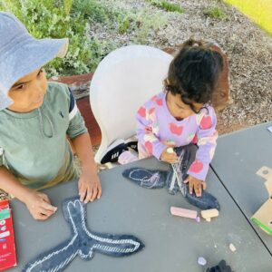 kids colouring in black cockatoo cutouts at the TTV april 2026 busy bee